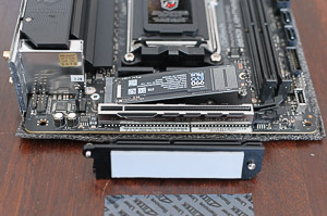 "Inserting the NVMe SSD drive -- don't forget to peel off the protective label from the heatsink's thermal pad"